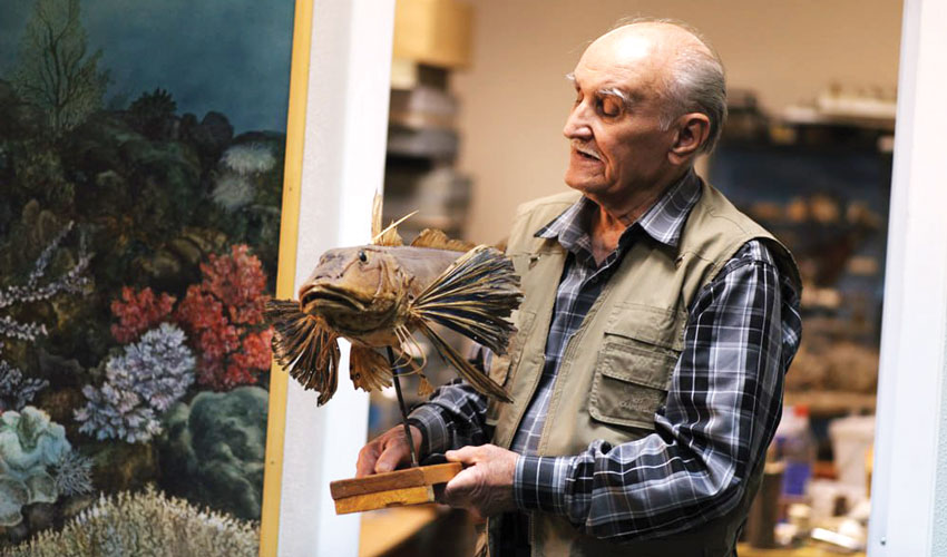 A museum curator with exhibits from “man unreasonable”
