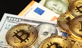 1605-close-up-bitcoins-paper-currency-table